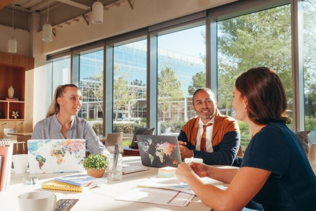 Three diverse professionals collaborate in a bright, modern workspace.