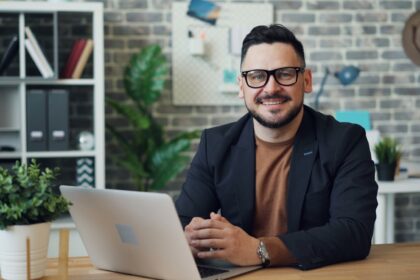 a man sitting at a table with a laptop